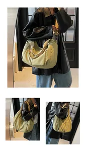 Detail of the large nylon dumpling bag featuring functional side zipper and wide shoulder strap