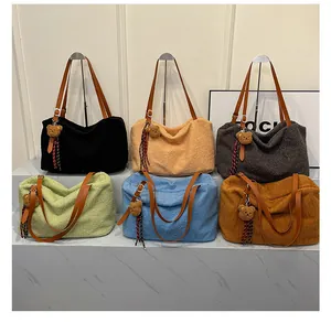 Detail of plush tote bags in multiple colors featuring leather handles and bear charms