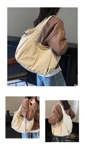 Macro view of multi-pocket nylon dumpling bag with adjustable wide shoulder strap