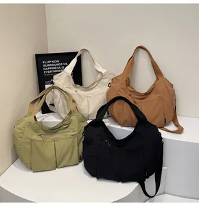 Detailed close-up of colorful nylon dumpling bags in beige, brown, green, and black colors