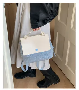 Detail showing white and blue contrast backpack with sparkling crystal embellishments