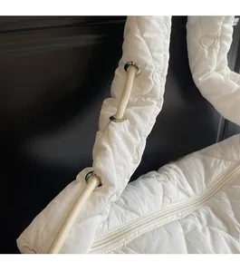 Détail du sac blanc matelassé en cœurs avec boucle de sangle à cordon réglable
