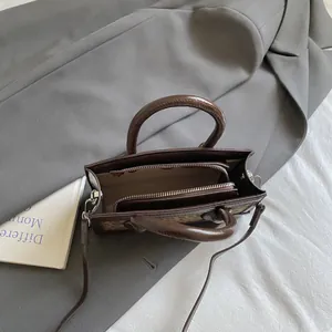 Brown vintage square handbag with leopard side detail and zipper interior shown from top view