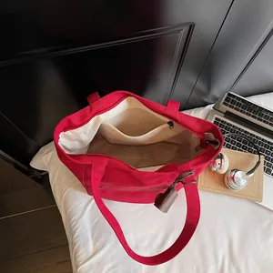 Large red canvas tote bag with interior zipper pocket and white fabric lining