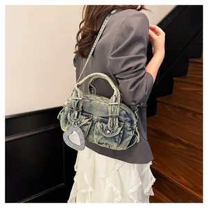 Detailed view of vintage denim bowling bag with sequins heart charm and shoulder strap