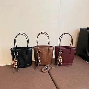 Vintage retro bucket bags in black, brown, and wine red with woven leather textures