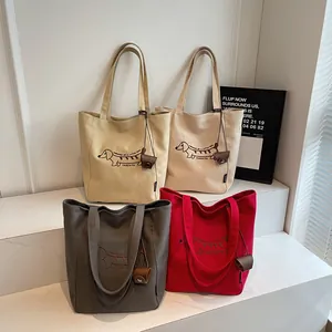 Minimalist canvas tote bags with embroidered dachshund dog patterns in various colors