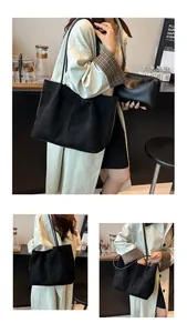 Detail showing high-quality matte black tote and matching pouch set in a cafe setting