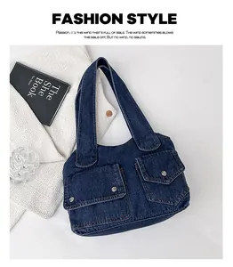 Detail der dunkelblauen Denim-Einkaufstasche mit zwei Pattentaschen und Metallknöpfen