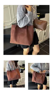 Brown suede tote bag detail featuring a matching small zipper pouch and slim shoulder straps