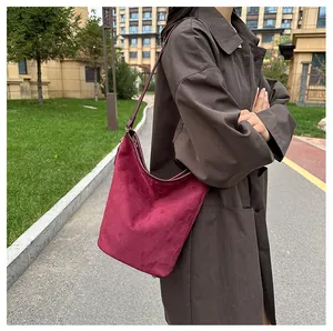 Detail der burgunderroten Wildleder-Hobo-Tasche mit Reißverschluss und Schultergurt