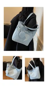 Detail of light blue canvas tote bag with side pocket and matching round coin purse pouch