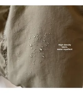Detailed macro view of khaki high-density ripstop fabric with water repellent droplets