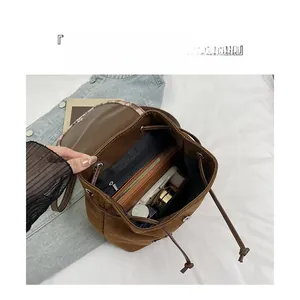 Internal view of a brown vintage backpack showing a spacious main compartment and pockets