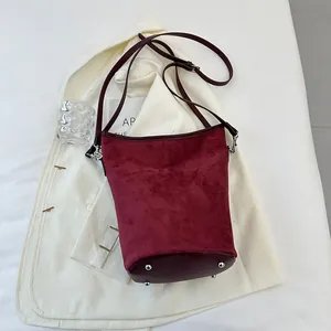 Detailansicht weinrote Eimer-Tasche aus Wildleder mit silbernen Taschenfüßen