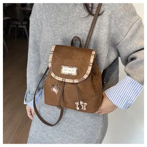 Detail of vintage brown backpack with star patchwork and serendipity embroidery