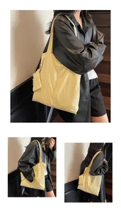 Three perspectives of a large light yellow tote bag with a small matching pouch charm
