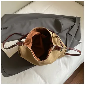 Detailed interior of khaki tote bag with dark caramel lining and silver zipper
