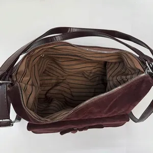 Retro oversized dark brown suede shoulder bag showing striped lining and interior pocket