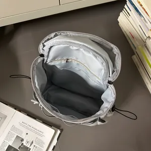 Spacious light grey waterproof nylon backpack with interior zipper pocket and drawstring