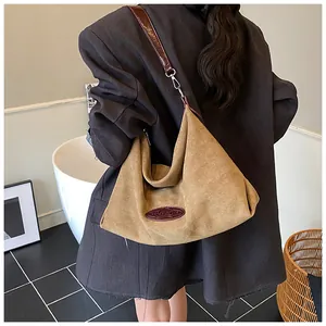 Detailed back view showing the slouchy khaki Hobo bag drape and dark brown leather strap