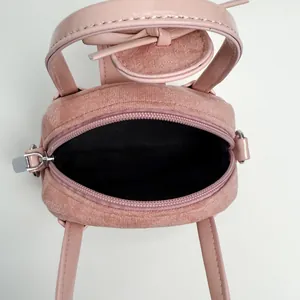 Chic pink fuzzy crossbody bag with smooth leather handles and a spacious main interior