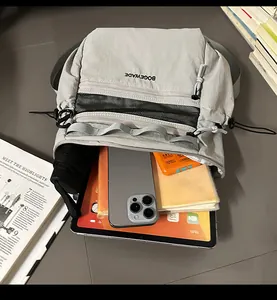 Spacious interior of light gray nylon bag showing pockets for tablet and phone