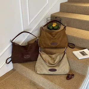 Minimalist large suede tote bags in brown and beige colors with leather straps