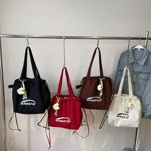 Minimalist drawstring nylon tote bag in four colors with decorative moon charms