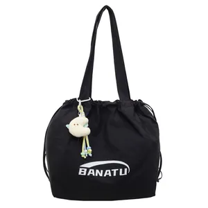 Lightweight black nylon drawstring tote bag with BANATU logo and plush moon pendant