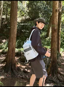 Outdoor light grey waterproof backpack with mesh pocket shown in a forest setting