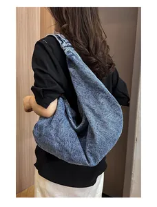 Detail of washed denim tote bag showing soft texture and spacious slouchy design