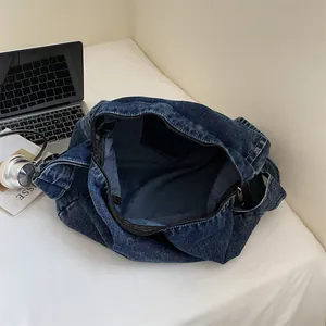 Retro deep blue denim tote bag with zipper closure shown with a laptop on a white desk