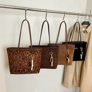 Suede tote bags in leopard and solid colors with beaded tassel charms and long straps