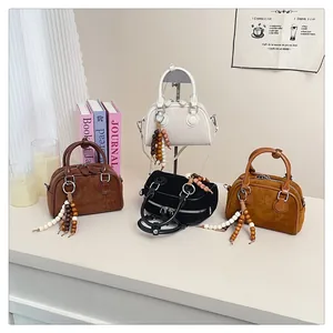 Collection of suede Boston bags in beige, brown, and black with leopard tassels