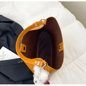Ginger brown large tote bag with magnetic closure and cute puppy charm on bed
