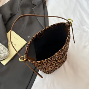 Chic leopard print suede bucket bag with brown adjustable shoulder strap and magnetic closure