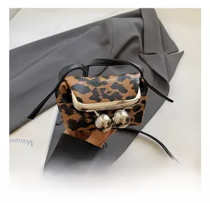 Detail der Mini-Tasche mit Leopardenmuster, großen silbernen Kugelverschlüssen und Metall