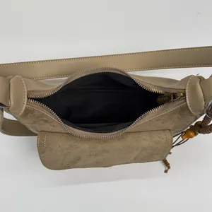 Minimalist beige leather tote bag with patchwork texture and decorative bead charm