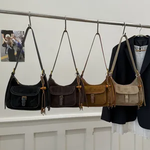 Retro suede half-moon shoulder bags in four colors with fringe and tassel details