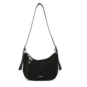 Black matte leather half-moon crossbody bag with vintage charm and unique tassel pendant