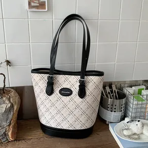 Fashionable diamond print bucket bag in beige with black trim for stylish commuting