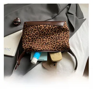 Macro view showing the internal capacity and suede leopard print texture of the shoulder bag