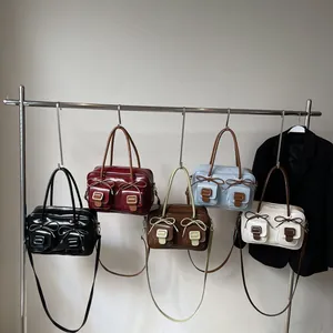 Fashionable bow-tie hobo bags in multiple colors shown hanging on a metal rack