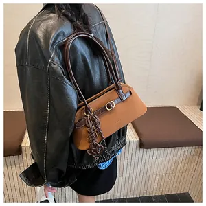 Detail of vintage brown textured leather bowling bag with metallic buckle and shoulder strap