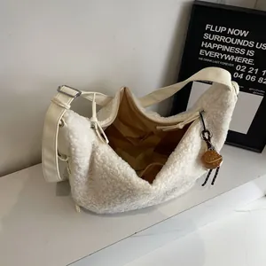 Minimalist beige wool tote bag with adjustable strap and basketball pendant detail