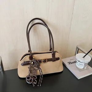 Retro khaki suede bowling bag with contrast brown leather straps and stylish charms