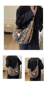 Detail view of the brown leopard print faux fur hobo bag with leather straps and charms