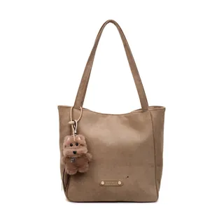 Vintage brown matte leather tote bag with large capacity and plush bear keychain decor
