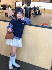 Detail showing creative brown handbag with shirt collar design and kid fashion accessories